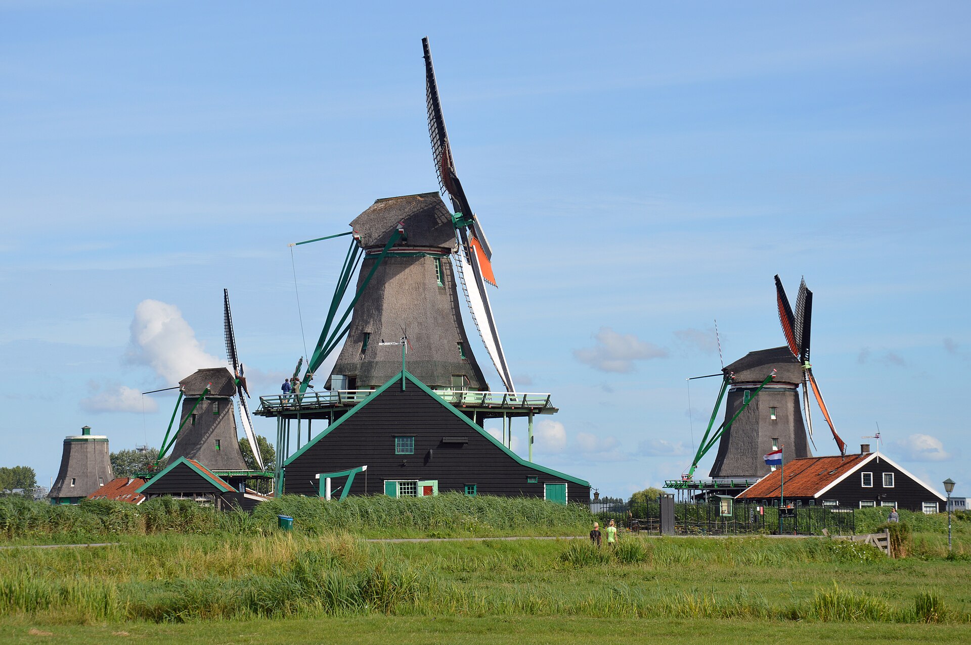 Traditional Dutch windmills beside a canal at Zaanse Schans